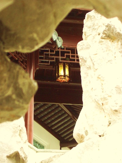 In a different light - the scene - looking through a Taihu rock on the Northern side of the Climbing Mountain half Pavilion, in the Dunedin Chinese Garden  " Lan Yuan."