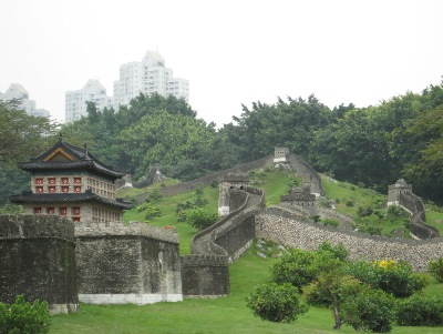 Splendid China's Great Wall, with the Skyscraper buildings of Shenzhen, in the distance.