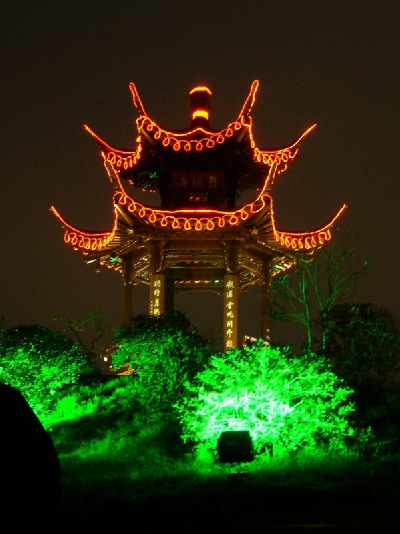 A pavilion is lit up above the wonderful lush foliage, of Yangzhou.