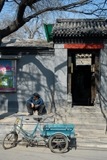 Pedicab outside Chinese buildings.