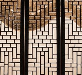 Searching through the lattice window in a Chinese garden pavilion.