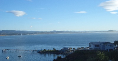 Moeraki township - the ' boulders ' are on the far away coastline, to the left end of the scene.